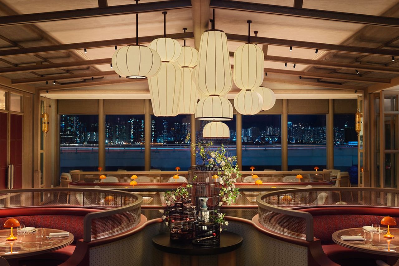 Warm restaurant pass at dusk, chef plating under pendant lights